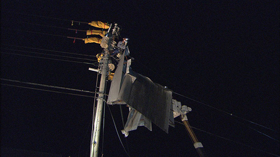 写真2：強風で吹き飛ばされた屋根状のものが引っかかった電線